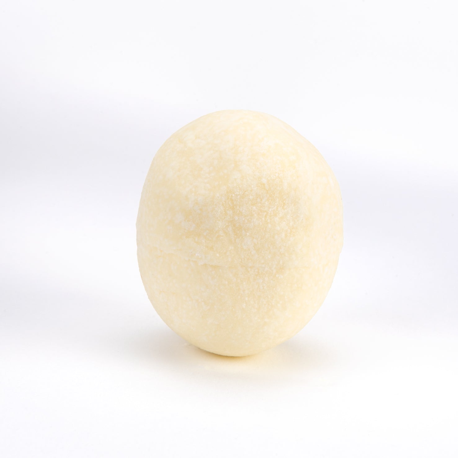A single smooth, oval-shaped pale cream or off-white object centered on a clean white background.